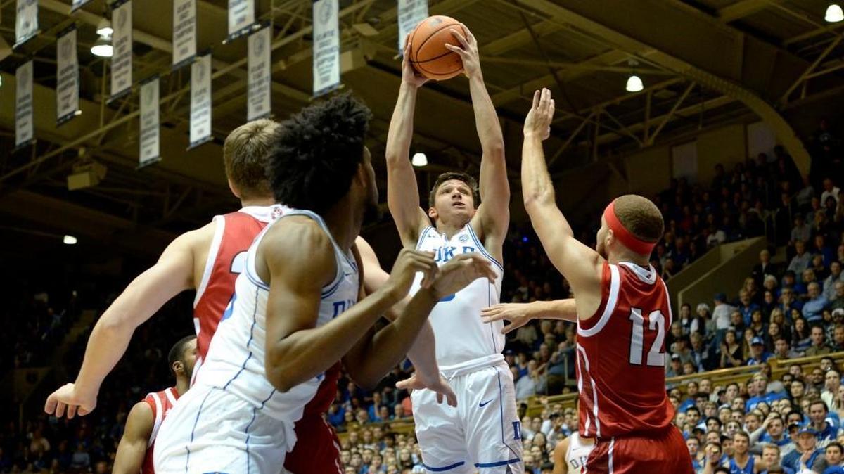 Duke guard Grayson Allen, middle, shoots over South Dakota forward Trey Burch-Manning, right, on Saturday.