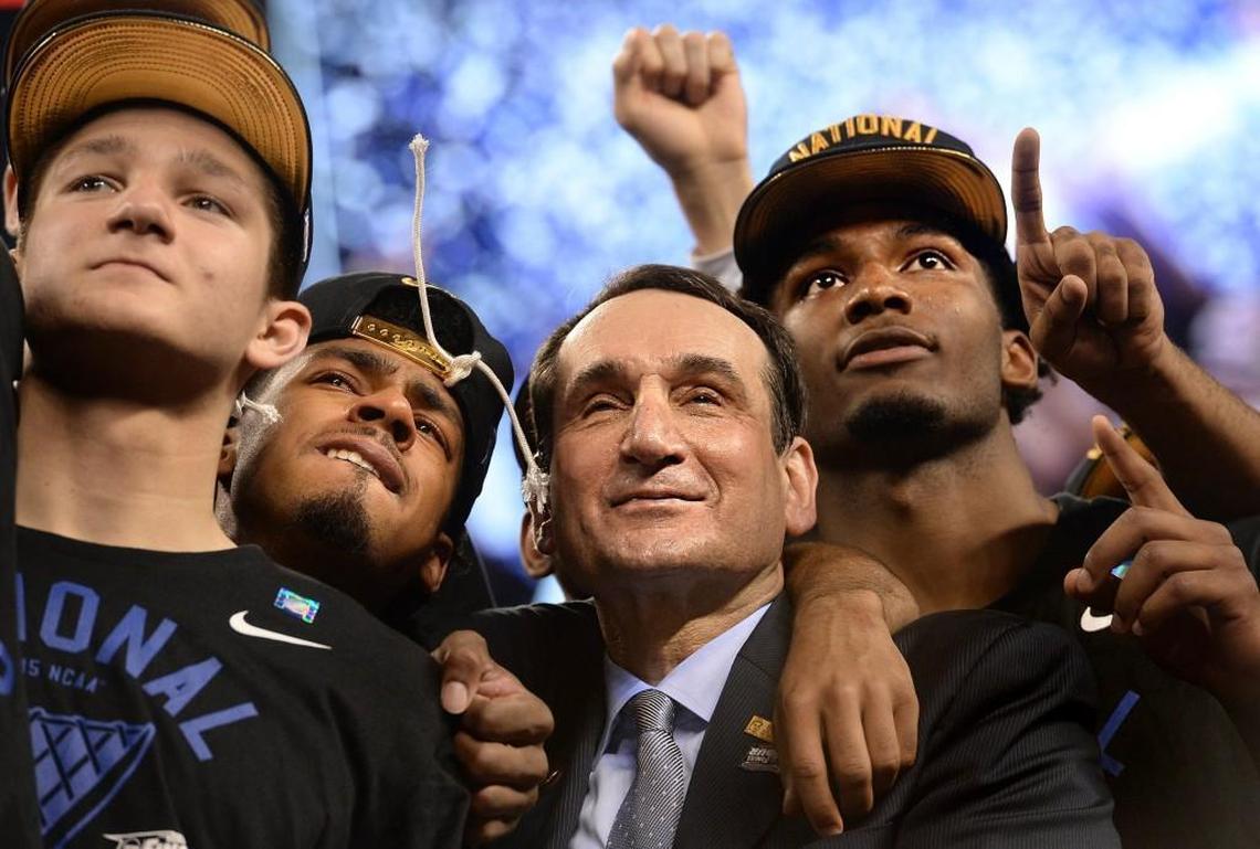 Mike Krzyzewski stands with, left to right, guard Grayson Allen, guard Quinn Cook and forward Justise Winslow as they watch "One Shining Moment" after Duke defeated Wisconsin 68-63 for the NCAA national championship on April 6, 2015.