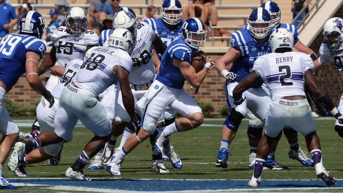 
Duke quarterback Thomas Sirk (1) tries to escape the rush of the Wildcat defense in the first half of play. Duke battled Northwestern in Wallace Wade Stadium at Duke University in Durham, N.C. Saturday, September 19, 2015.
