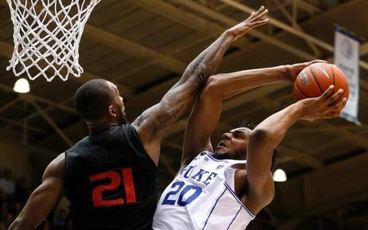 Duke's Marques Bolden (20) shoots as Miami's Kamari Murphy (21) defends during the second half at Cameron Indoor Stadium.