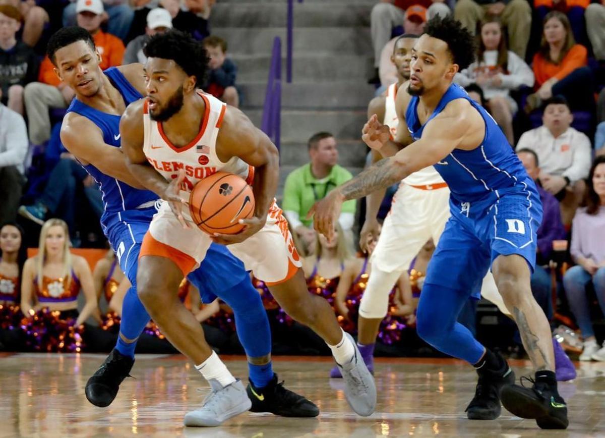 Clemson guard Gabe DeVoe (10) is double teamed by Duke guard Trevon Duval (1) and guard Gary Trent Jr. (2) in the second half.