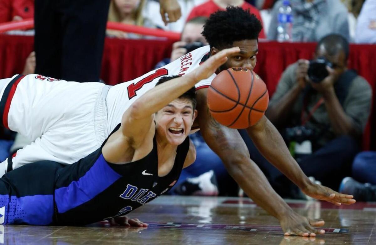 Duke’s Grayson Allen, left, and N.C. State’s Lennard Freeman go after a loose ball during the Wolfpack’s 96-85 win over the Blue Devils on Jan. 6.