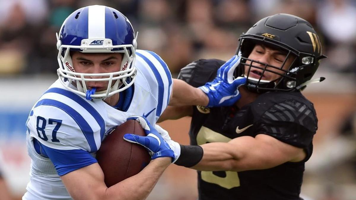 Duke’s Max McCaffrey tries to get away from Wake Forest’s Zach Dancel.