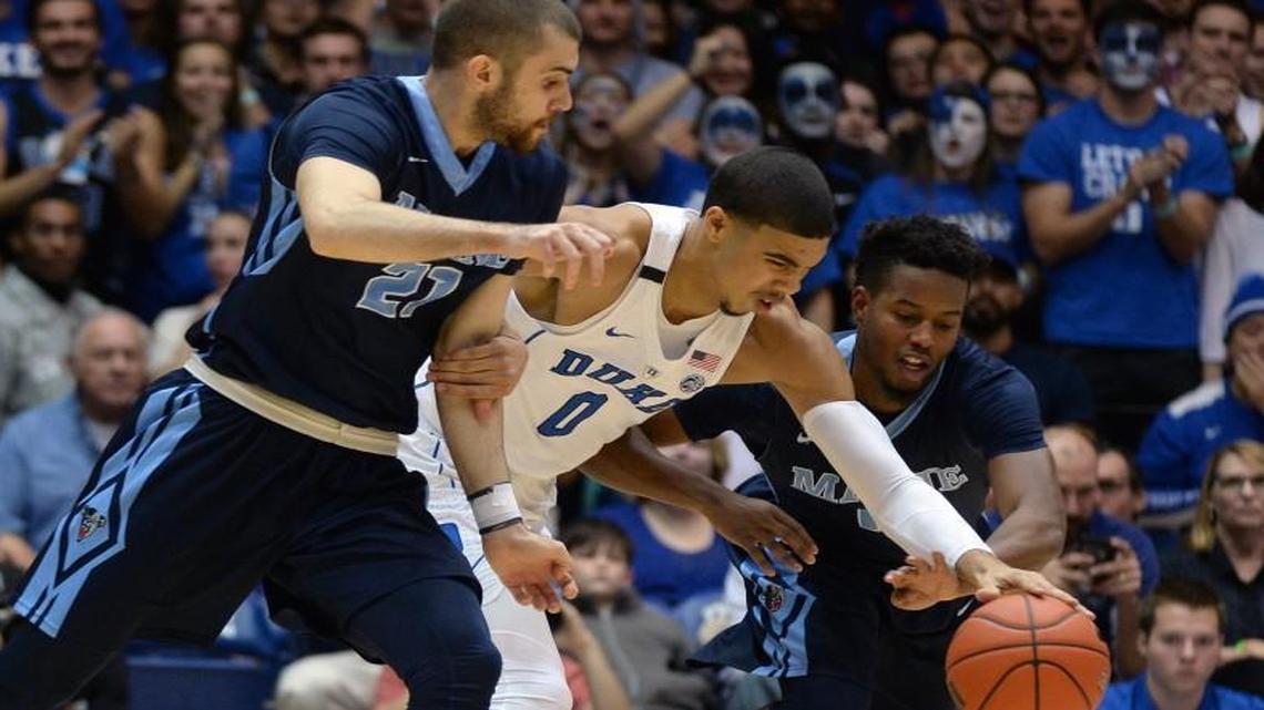 Duke’s Jayson Tatum (0) steals the ball from Maine’s Ilker Er(21) and Wesley Myers (10) at Cameron Indoor Stadium in Durham.