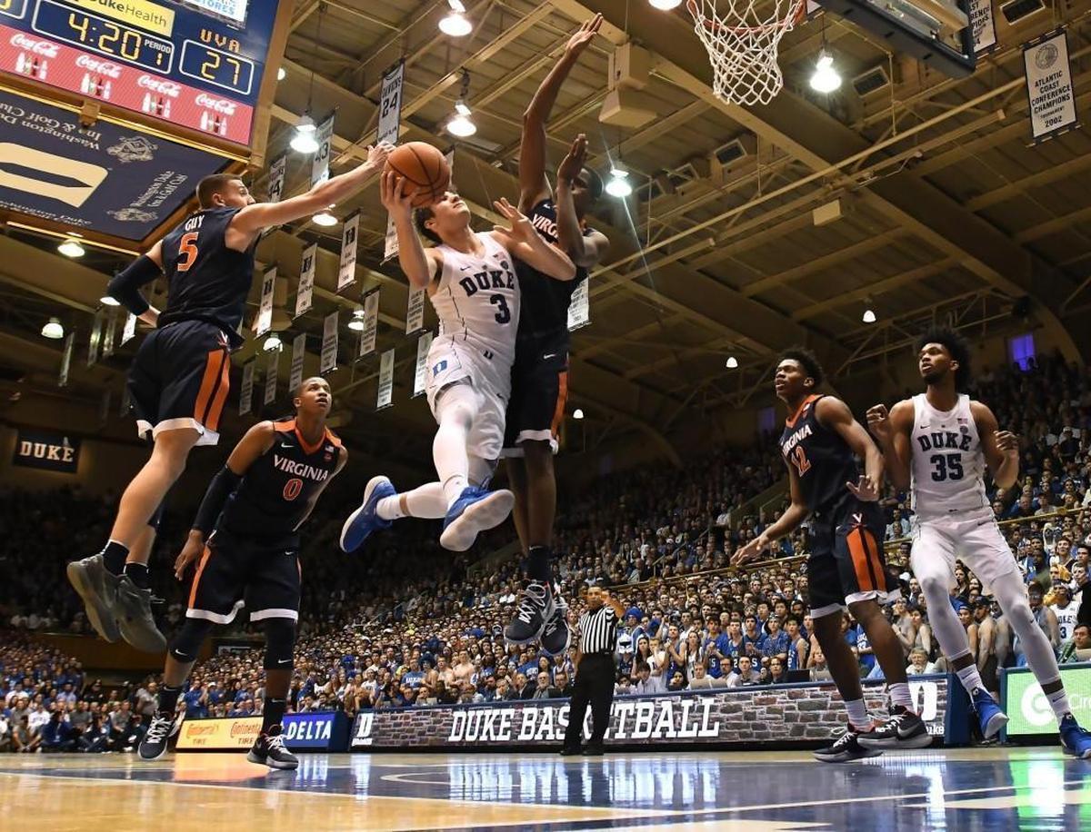 Duke guard Grayson Allen (3) goes in to attempt a first half shot against the Virginia defense. Duke battled Virginia at Cameron Indoor Stadium In Durham on Saturday, Jan. 27, 2018