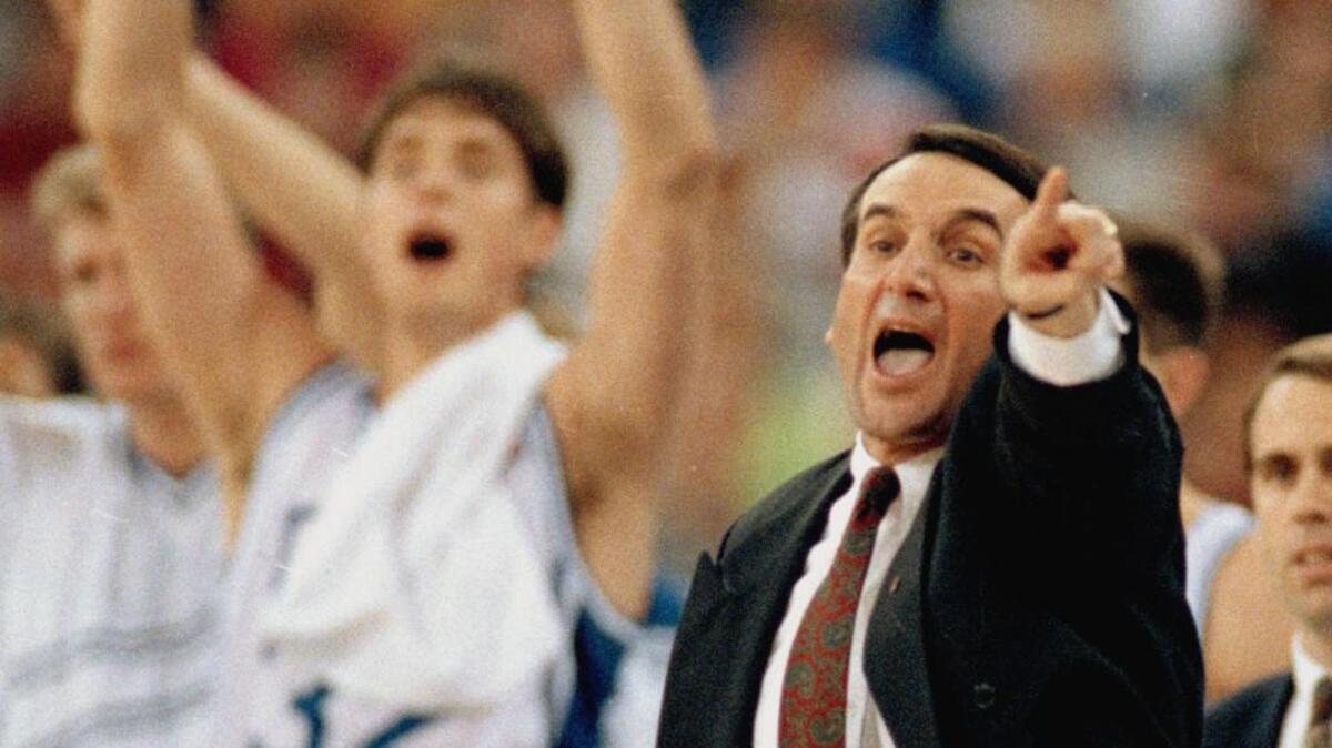 Duke coach Mike Krzyzewski directs his team as Christian Laettner cheers during the 1991 NCAA championship game against Kansas.