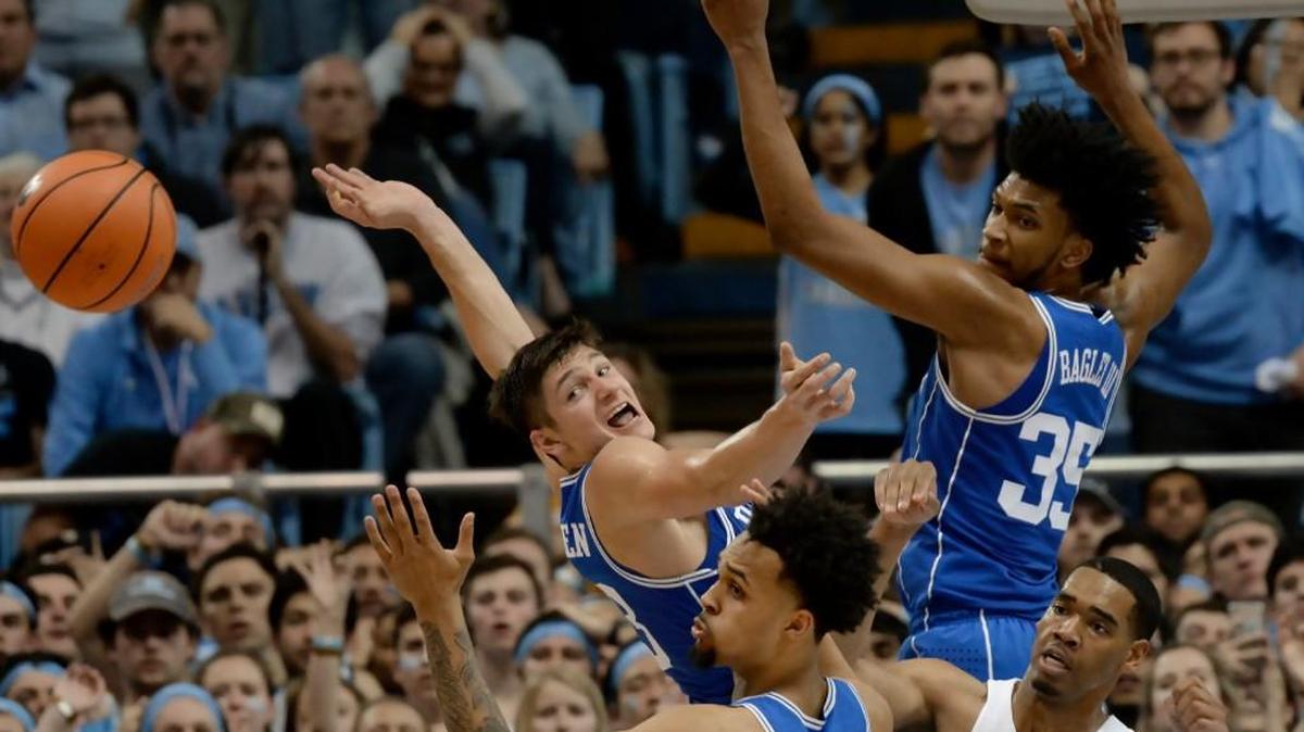 Duke forward Marvin Bagley III (35), Grayson Allen (3) and guard Gary Trent Jr. (2) aren't able to corral a rebound as UNC forward Garrison Brooks (15) kicks the ball outside to a teammate in the second half.