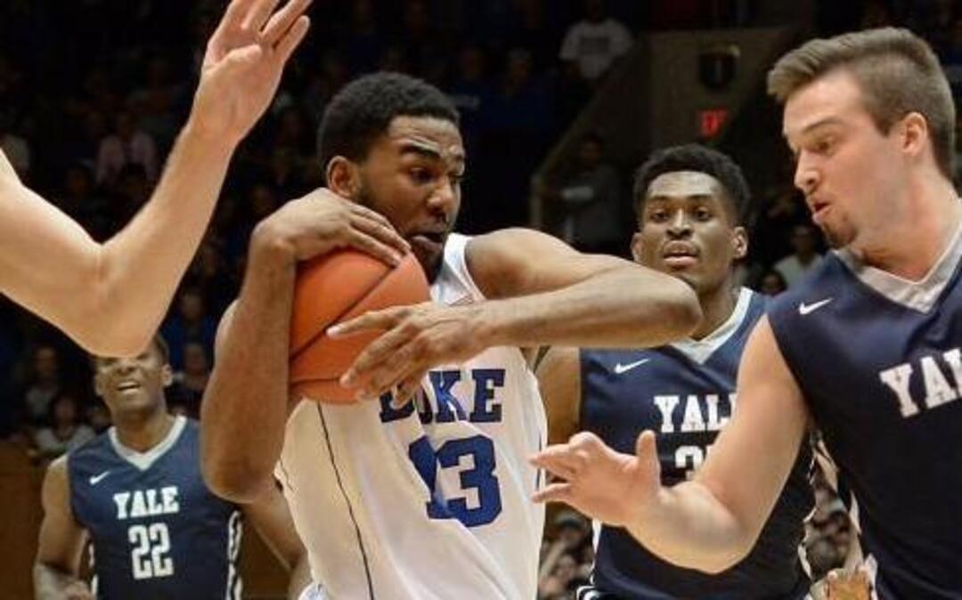 Duke guard Matt Jones (13) tries to move the ball inside against Yale’s Nick Victor (21) and Jack Montague (4) during the first half of play at Cameron Indoor Stadium in Durham, N.C. Wednesday, November 25, 2015.