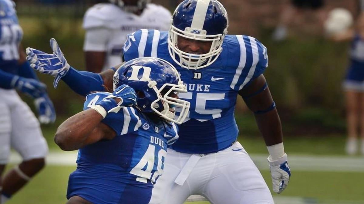 
Duke defensive end Deion Williams (48) reacts with teammate defensive tackle Brandon Boyce (55) after a first-quarter sack of Northwestern quarterback Clayton Thorson. 
