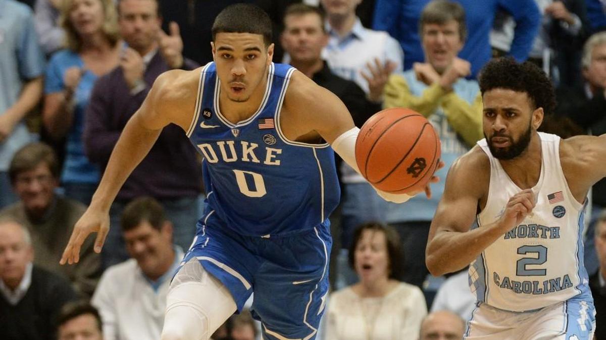 Duke forward Jayson Tatum (0) takes off on a fast break as UNC guard Joel Berry II (2) trails the play in the Tar Heels win over the Blue Devils on March 4.
