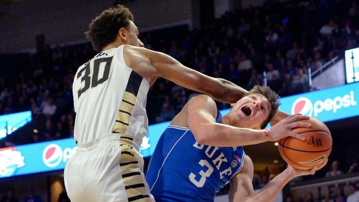 Duke guard Grayson Allen (3) is fouled by Wake Forest center Olivier Sarr (30) in first half action.