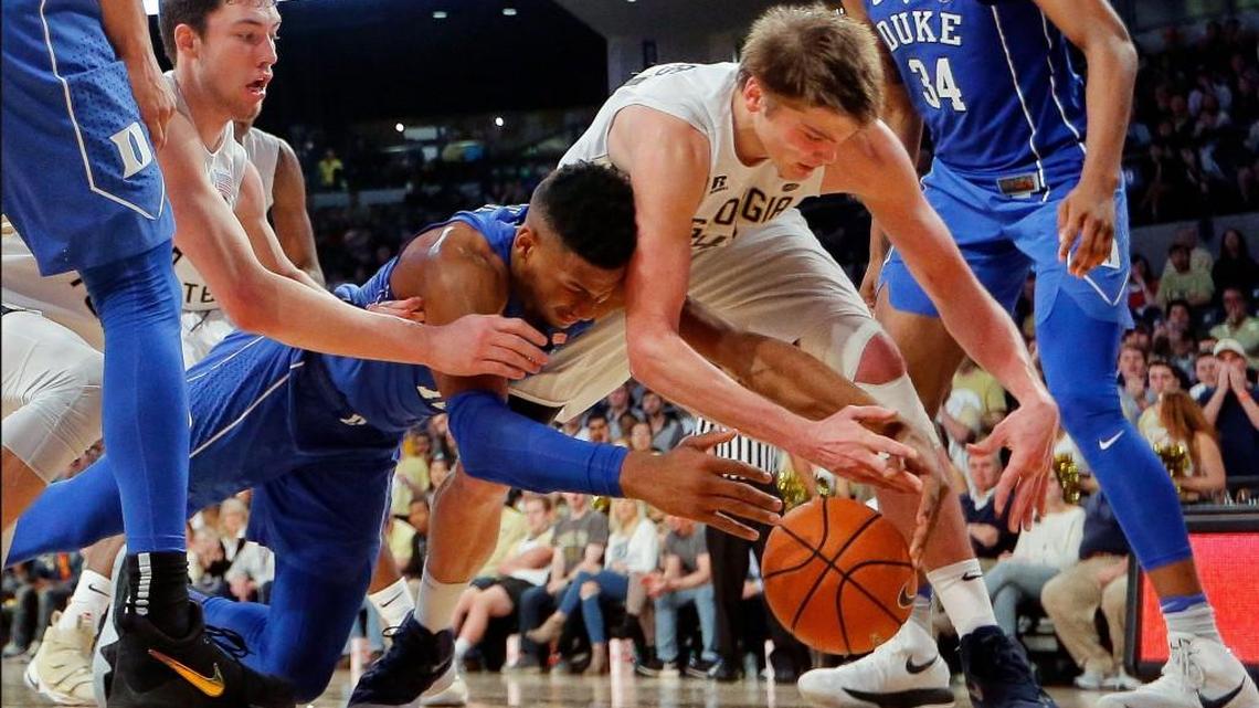 Duke forward Javin DeLaurier, center left, battles Georgia Tech's Ben Lammers, center right, and Evan Cole, back left, for the ball in the second half.