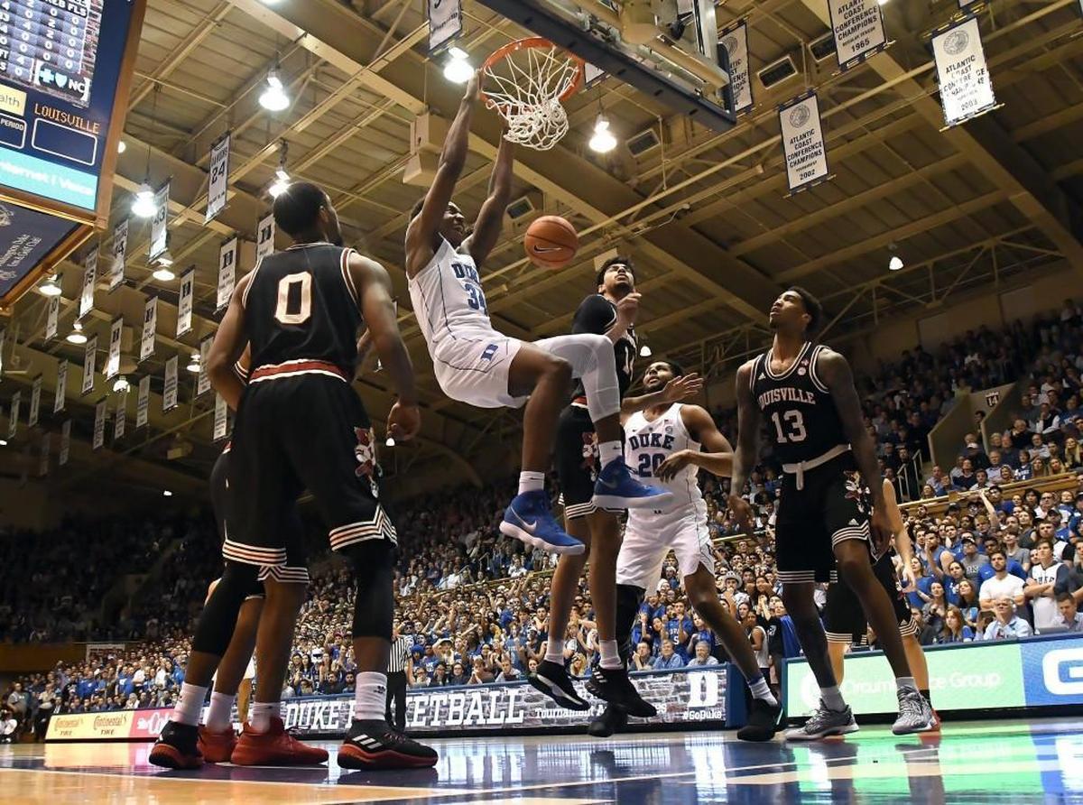 Duke forward Wendell Carter Jr. (34) jams home a dunk over the Louisville defense in the first half of play. Duke battled Louisville at Cameron Indoor Stadium in Durham on Wednesday, Feb. 21, 2018.