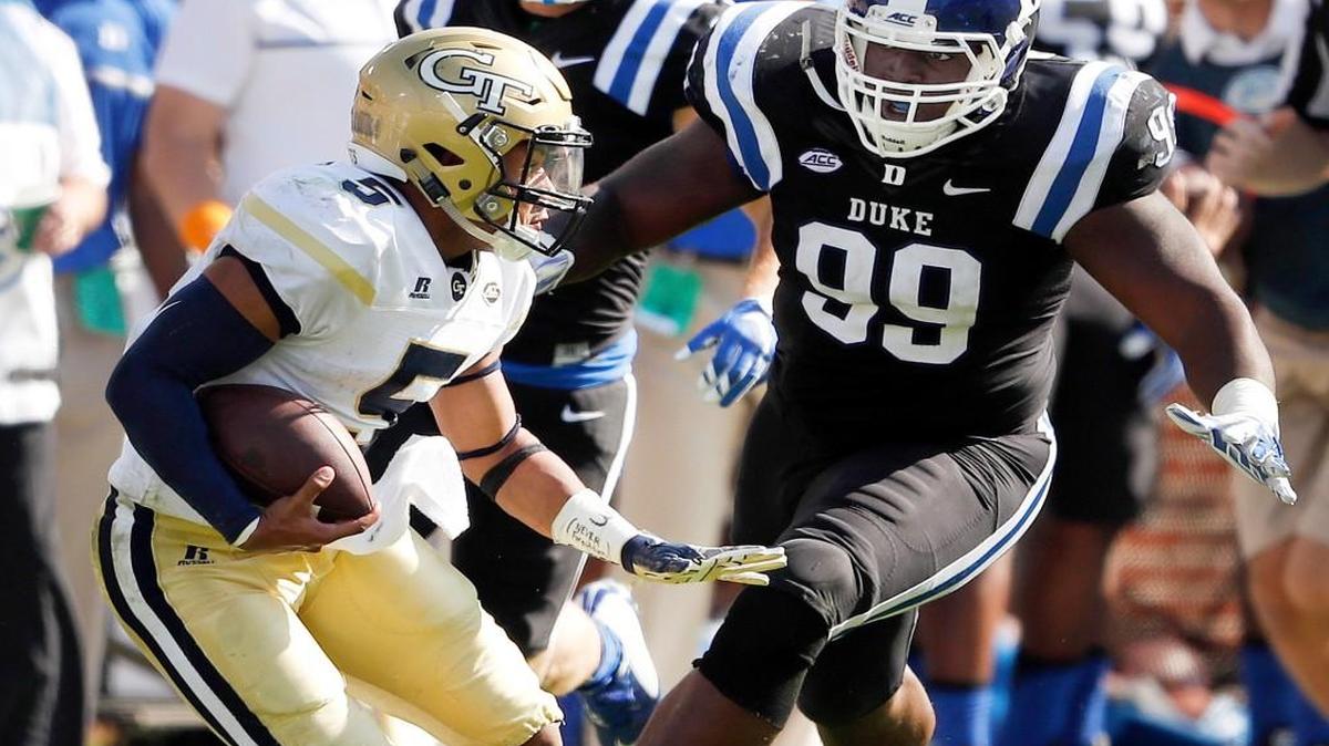 Georgia Tech quarterback Justin Thomas (5) tries to escape from Duke defensive tackle Mike Ramsay (99) after a long gain in the second half of an NCAA college football game Saturday, Oct. 29, 2016, in Atlanta. Georgia Tech won 38-35.