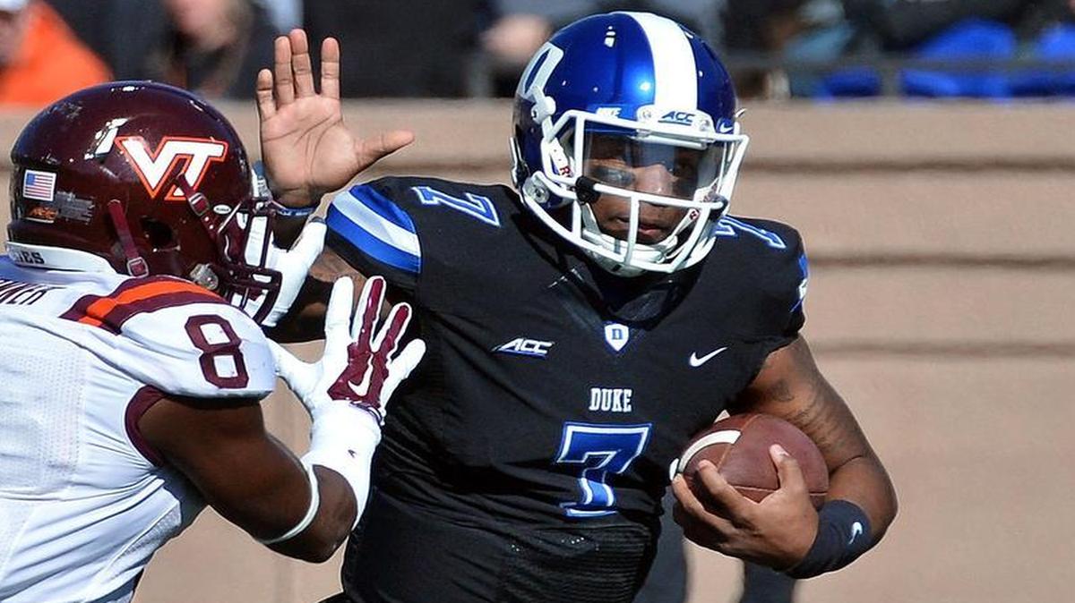 
Duke quarterback Anthony Boone (7) attempts to avoid Virginia Tech safety Detrick Bonner (8) as he runs for a first down during their game at Wallace Wade Stadium in Durham Saturday, November 15, 2014.
