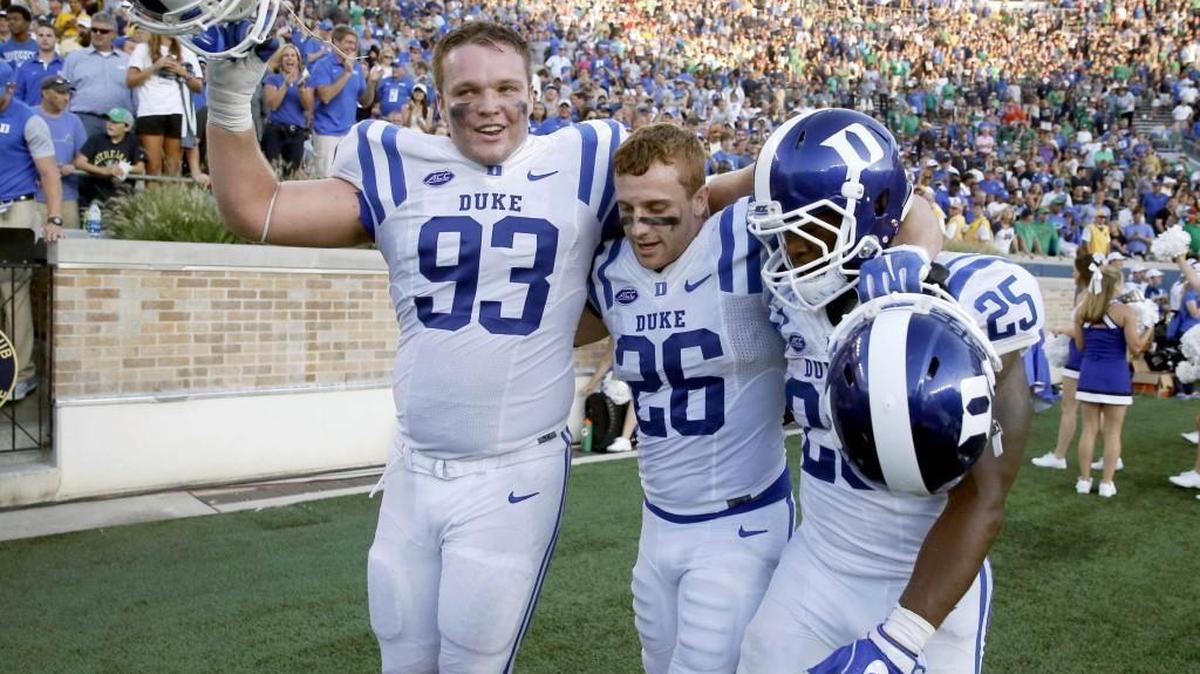 Duke's A.J. Wolf, left, Corbin McCarthy (26) and Jela Duncan celebrate their win over Notre Dame on September 25 in South Bend, Ind. (AP Photo/Charles Rex Arbogast)