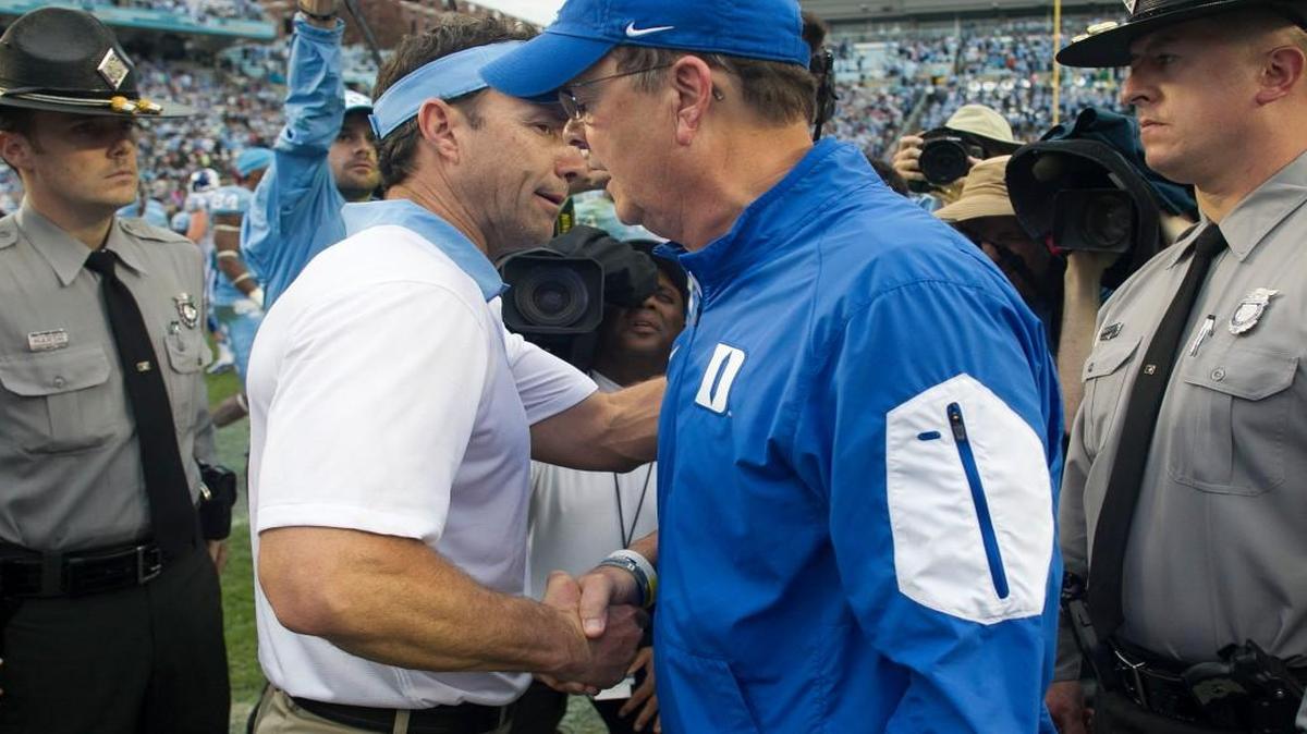 Duke coach David Cutcliffe congratulates North Carolina coach Larry Fedora following the Tar Heels’ 66-31 victory over Duke on Nov. 7, 2015 at Kenan Stadium in Chapel Hill.