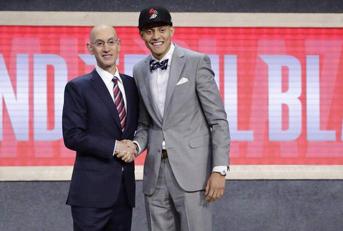 Justin Jackson poses for photos with NBA Commissioner Adam Silver after being selected by the Portland Trail Blazers as the 15th pick overall during the NBA basketball draft, Thursday, June 22, 2017, in New York.