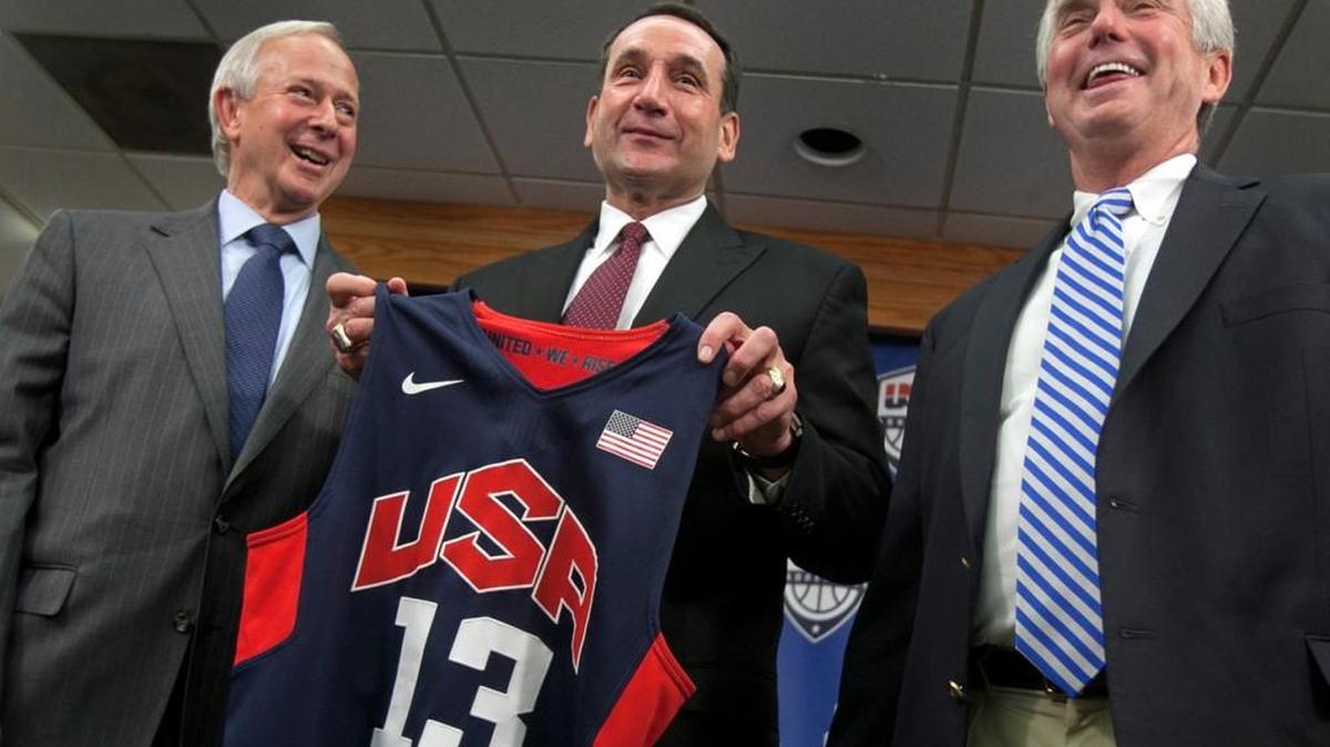 
Duke basketball coach Mike Krzyzewski, center, holds a Team USA jersey, as he is flanked by school President Richard Broadhead, left, and Director of Athletics Kevin White at a news conference in 2013. 
