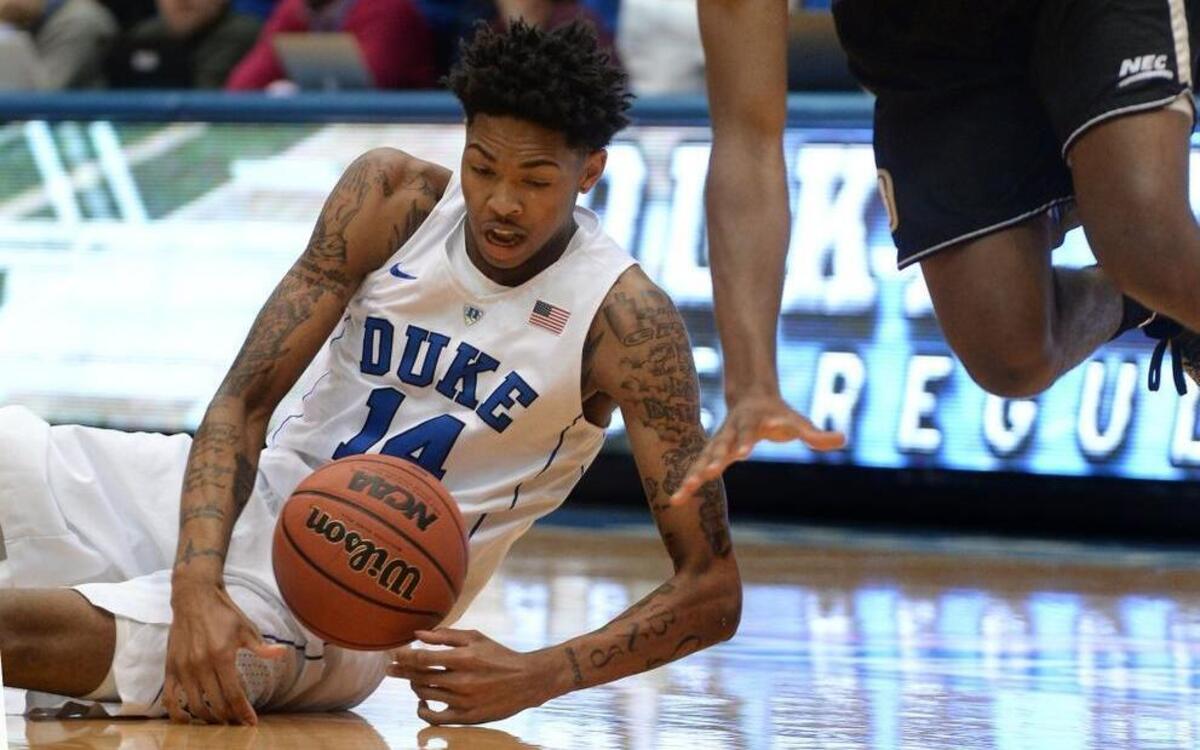 Duke guard Brandon Ingram (14) goes to the floor to retrieve a loose ball that Bryant guard Hunter Ware (1) lost during the first half.