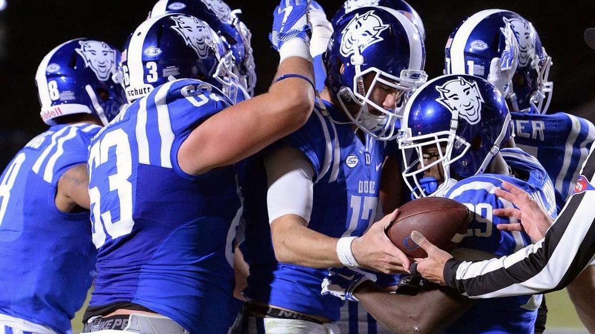 Duke quarterback Daniel Jones (17) is mobbed by teammates after scoring against UNC in November. The Blue Devils on Wednesday announced start times for four games.