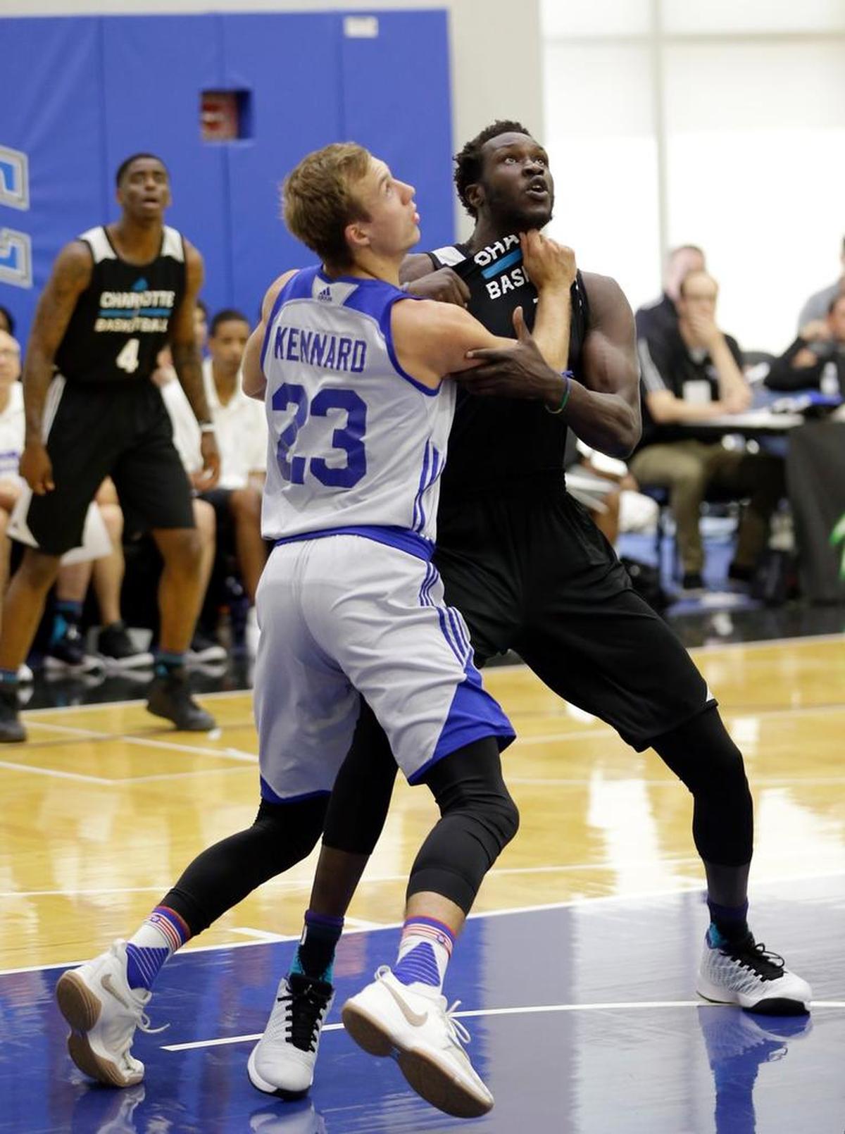 The Pistons’ Luke Kennard, left, fights for position to get a rebound against the Hornets’ Mangok Mathiang during Detroit’s summer league win over Charlotte on Wednesday.
