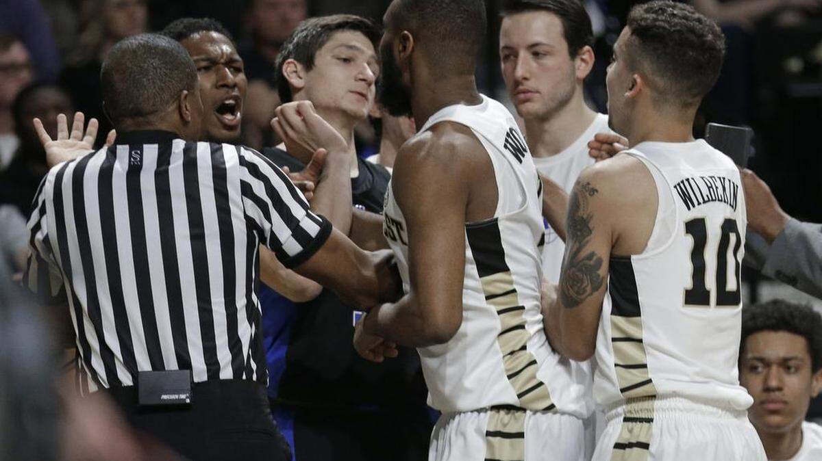 Duke's Grayson Allen, third from left, tries to walk away from an altercation between Duke and Wake Forest players.