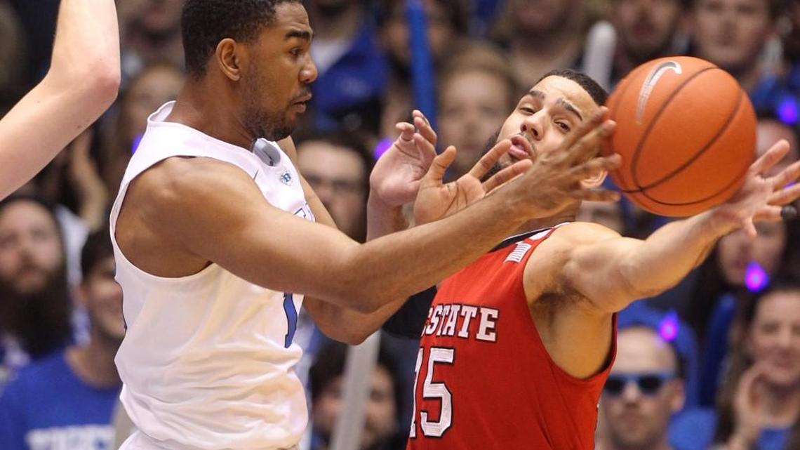 Duke's Matt Jones (13) passes around the pressure by N.C. State's Cody Martin (15) during the first half of the Wolfpack's game against Duke at Cameron Indoor Stadium in Durham, N.C., Saturday, Feb. 6, 2016.
