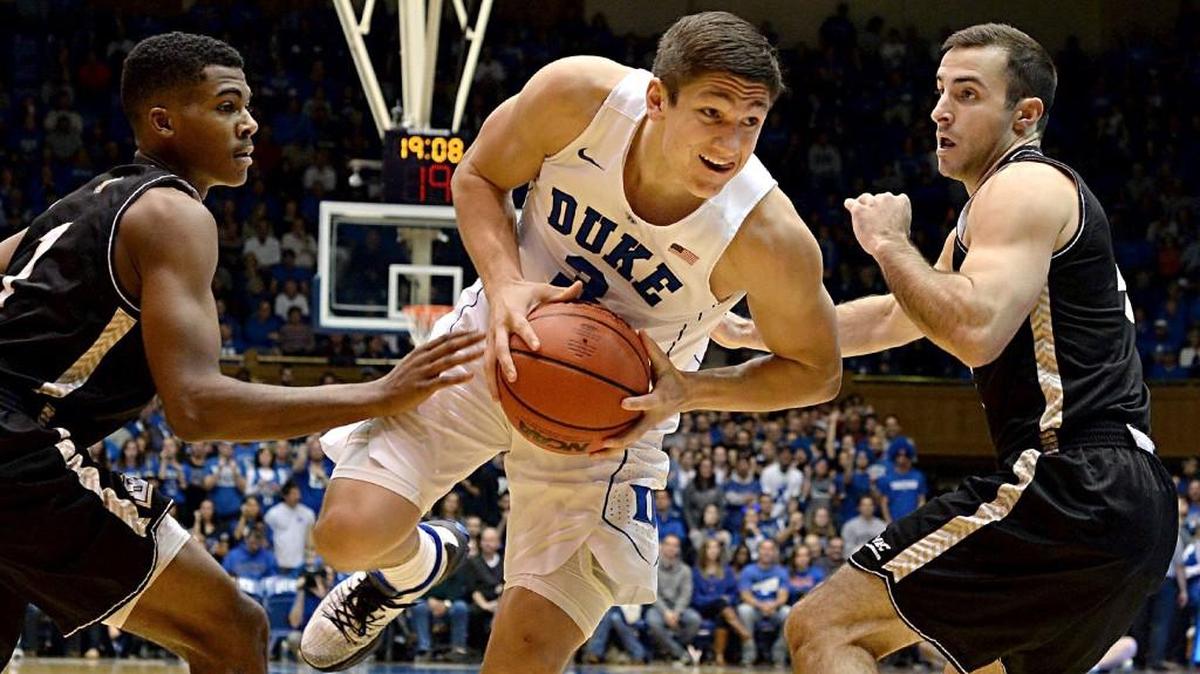 Duke guard Grayson Allen (3) splits Bryant guard Hunter Ware (1) and teammate Bryant guard Shane McLaughlin (4) during first half action at Cameron Indoor Stadium in Durham, N.C. Saturday, Nov. 14, 2015.