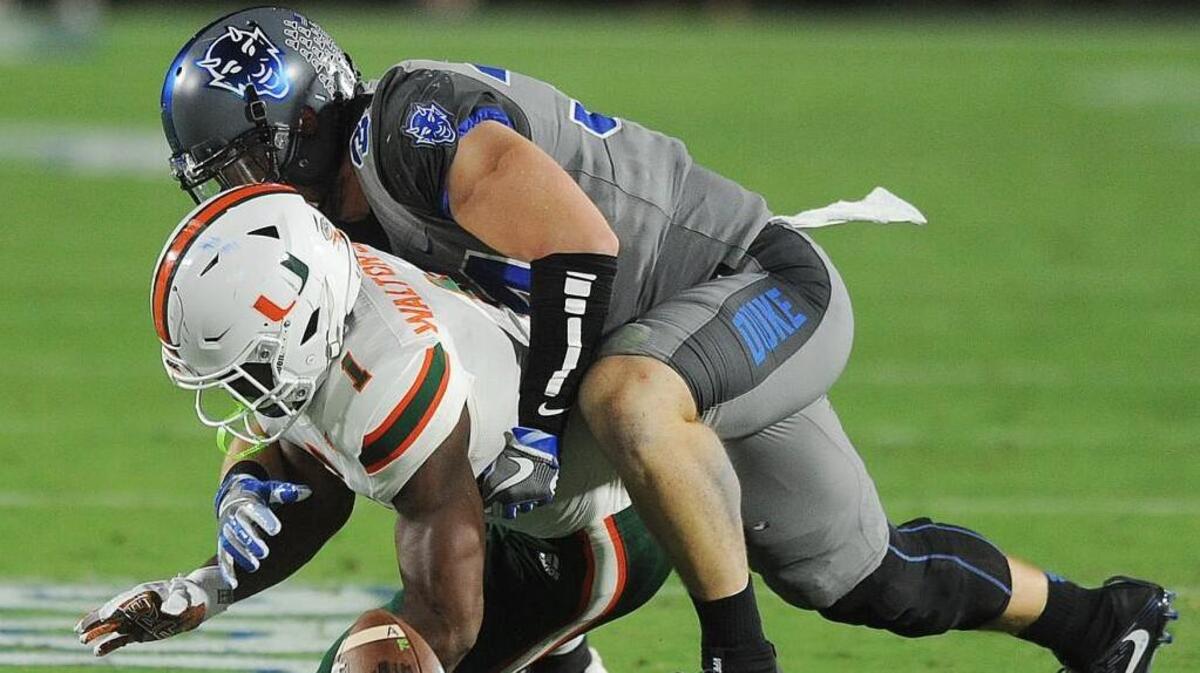 Duke’s Ben Humphreys, right, tackles Miami’s Mark Walton on Sept. 29. Humphreys, who’s been out with a leg injury, is expected to play in the Blue Devils’ bowl game on Dec. 26.