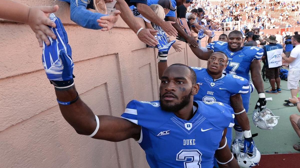 
Duke wide receiver Jamison Crowder, from left, running back Josh Snead and guard Laken Tomlinson are congratulated by fans after Duke beat Virginia 20-13 at Wallace Wade Stadium in Durham, Sept. 18, 2014.
