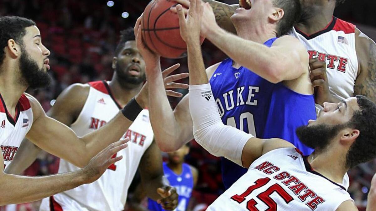 Duke’s Marshall Plumlee (40) heads to shoot as N.C. State’s BeeJay Anya (21), right, Cody Martin (15), bottom right, and Caleb Martin (14) guard him during the Blue Devils win over the Wolfpack Saturday. The game with N.C. State, plus Duke’s matchup against Miami Monday, are sandwiched between two long breaks for the Blue Devils.