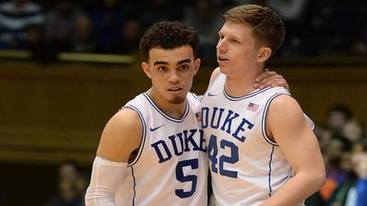 
Duke reserve Sean Kelly (42) gives freshman guard Tyus Jones (5) a hug as he subs him out near game’s end against Clemson Saturday, Feb. 21, 2015 at Cameron Indoor Stadium in Durham, NC.
