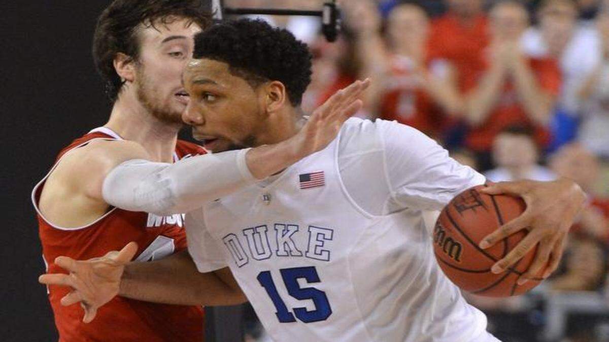
Duke's Jahlil Okafor (15) drives against Wisconsin's Frank Kaminsky (44) during the first half in the 2015 Division I Men's Basketball Championship game at Lucas Oil Stadium in Indianapolis.
