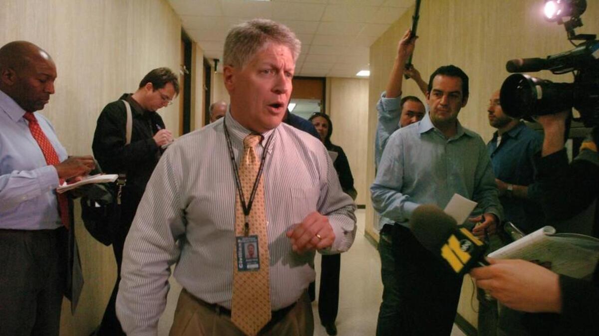 Durham District Attorney Mike Nifong is surrounded by the media after coming out of his office at the Durham County Judicial Building shortly after results from DNA tests failed to connect any members of the Duke University lacrosse team to the alleged rape of a stripper were obtained by his office on April 10, 2006. In March, ESPN is airing “Fantastic Lies,” a new documentary about the Duke lacrosse case.