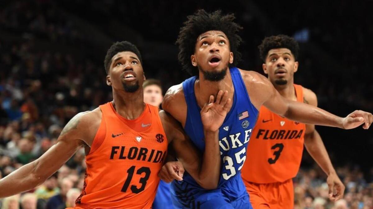 Florida’s Kevarrius Hayes, left, and Jalen Hudson, right, surround Duke’s Marvin Bagley in the Blue Devils’ win over the Gators in the PK80 championship game on Sunday.
