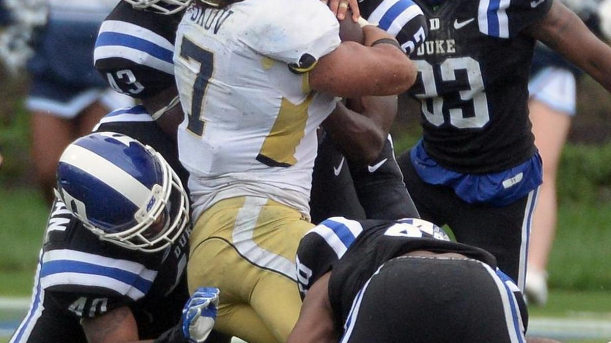 Duke defenders linebackers Tinashe Bere (43) and Dwayne Norman (40) stop Georgia Tech’s Patrick Skov (7) in a crucial play on fourth-and-short late in the fourth quarter.