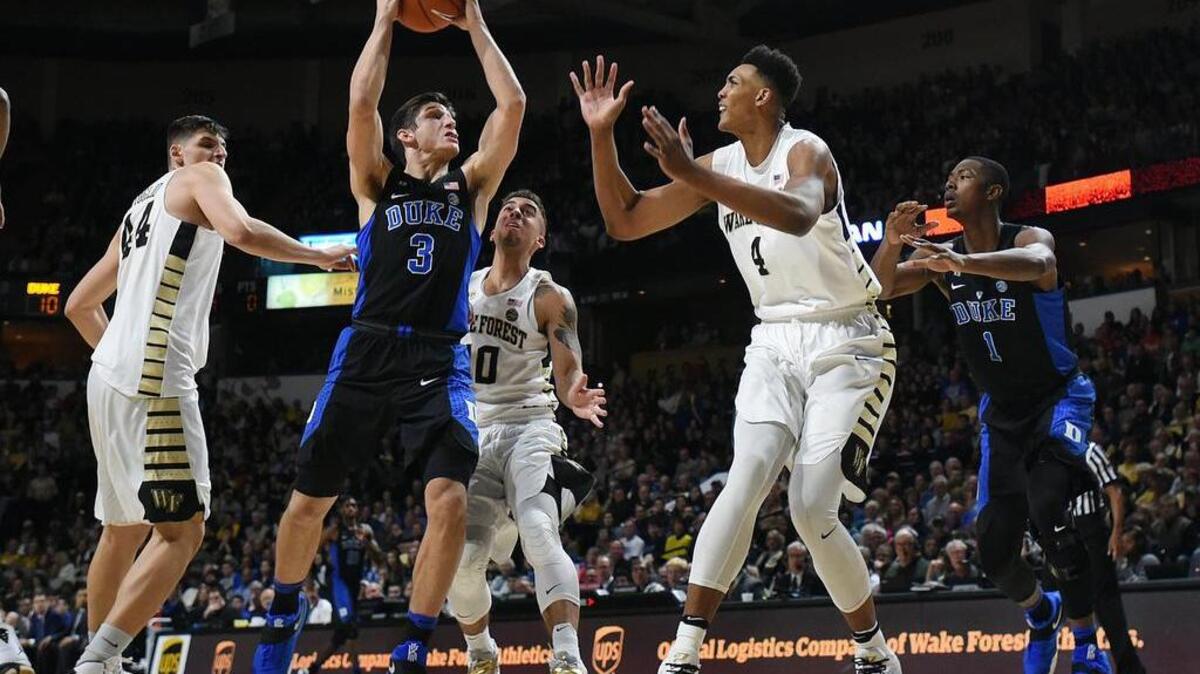 Grayson Allen (3) goes against Wake Forest center Doral Moore (4) in the Blue Devils’ 85-83 win on Jan. 28.