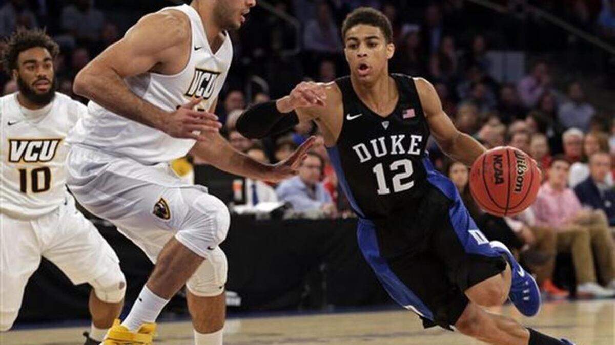 Duke guard Derryck Thornton, right, drives to the basket past Virginia Commonwealth forward Ahmad Hamdy-Mohamed, left, during the second half at Madison Square Garden in New York.