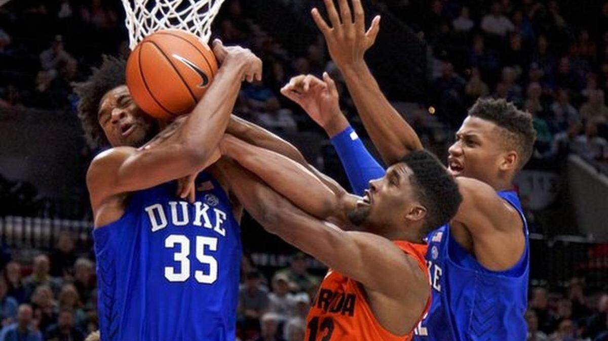 Duke forward Marvin Bagley III, left, Duke forward Javin DeLaurier, right and Florida forward Kevarrius Hayes, center, fight for a rebound during the second half of an NCAA college basketball game in the Phil Knight Invitational tournament in Portland, Ore., Sunday, Nov. 26, 2017.
