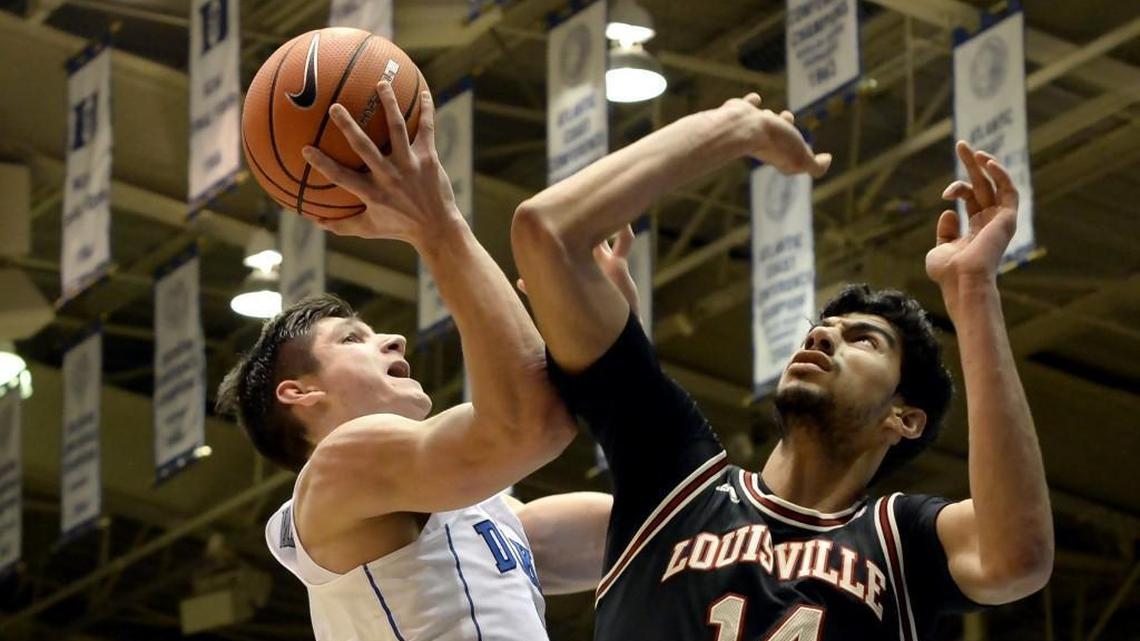 Duke guard Grayson Allen (3) goes up for a first-half shot over Louisville forward Anas Mahmoud (14). Duke battled Louisville at Cameron Indoor Stadium in Durham on Wednesday, Feb. 21, 2018.