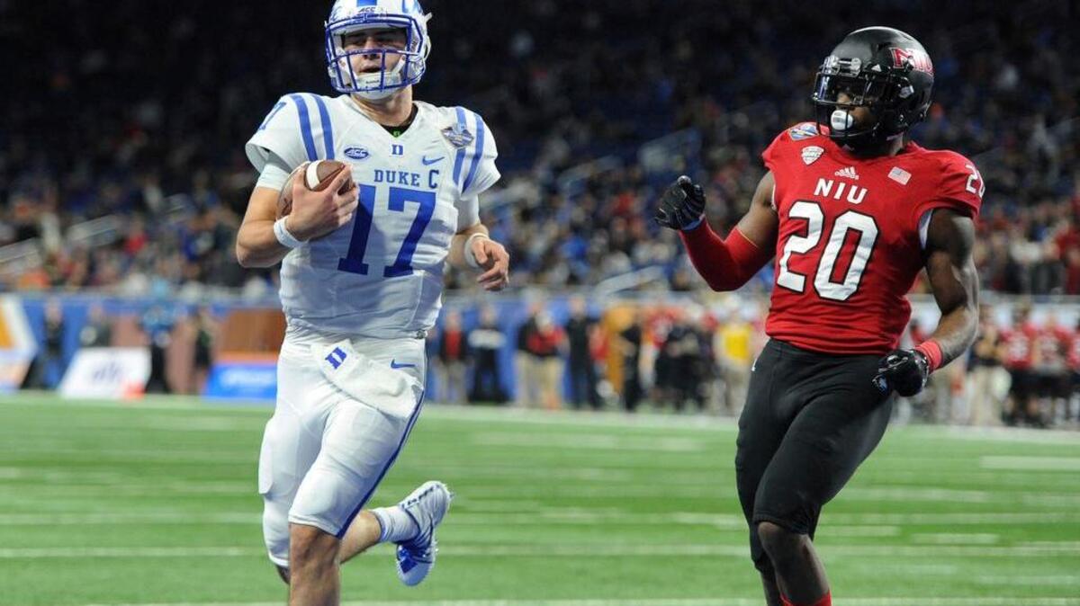 Duke quarterback Daniel Jones (17) runs for a touchdown past Northern Illinois safety Mycial Allen (20) during the first quarter of the Quick Lane Bowl NCAA college football game, Tuesday, Dec. 26, 2017, in Detroit.