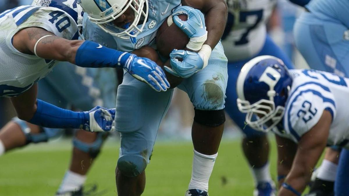 North Carolina tailback Elijah Hood (34) beats Duke's Dwayne Norman (40) to the end zone a four yard run to give the Tar Heelsâ a 21-3 lead over Duke in the first quarter on Saturday, November 7, 2015 at Kenan Stadium in Chapel Hill, N.C.