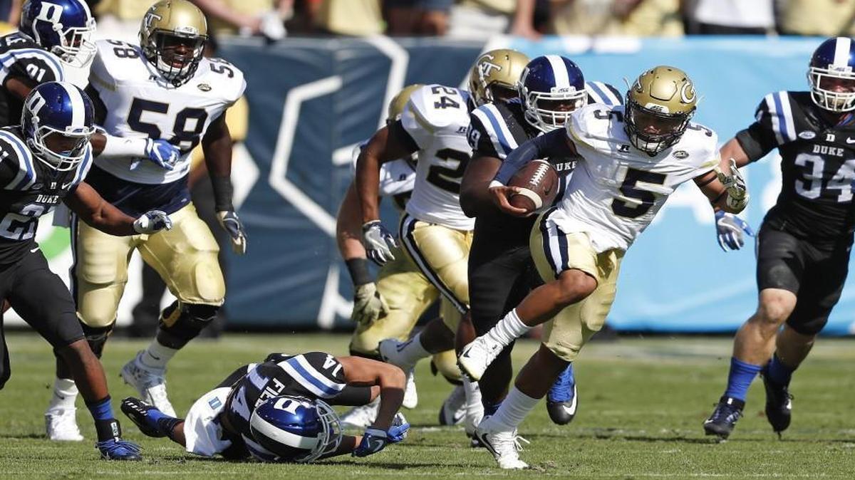 Georgia Tech quarterback Justin Thomas (5) breaks through the Duke defense as he runs for a touchdown in the first half in Atlanta.