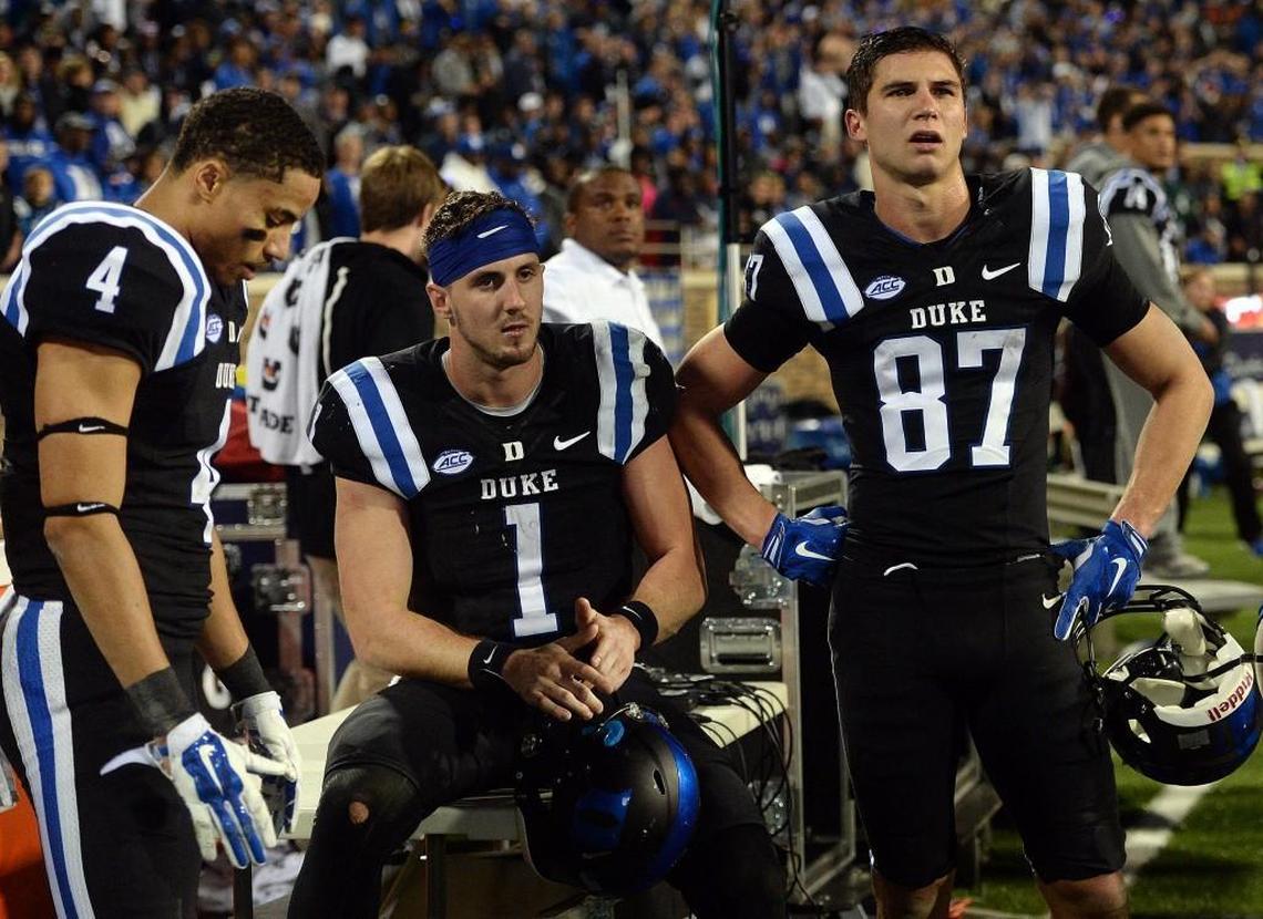 Duke wide receiver Johnell Barnes, left, quarterback Thomas Sirk, middle, and wide receiver Max McCaffrey, right, sit on the sidelines as Miami’s kickoff return is reviewed by game officials on Oct. 31, 2015.