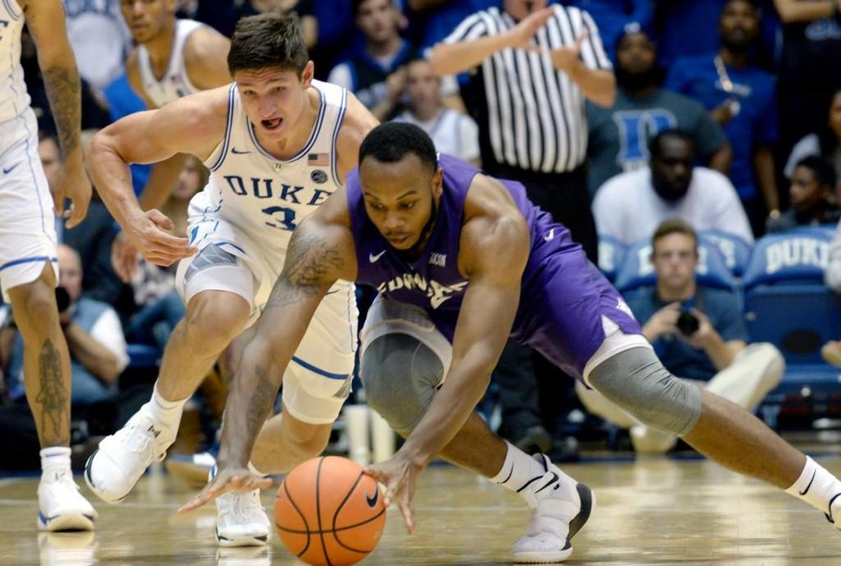 Duke guard Grayson Allen (3) and Furman forward Jalen Williams (2) battle for a loose ball in the first half.