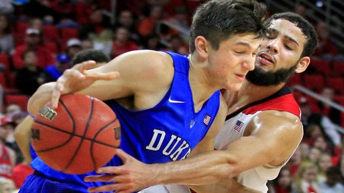 N.C. State's Cody Martin (15) fouls Duke's Grayson Allen (3) as he goes for the ball during the second half of Duke's 88-78 victory over N.C. State at PNC Arena in Raleigh, N.C., Saturday, Jan. 23, 2016.