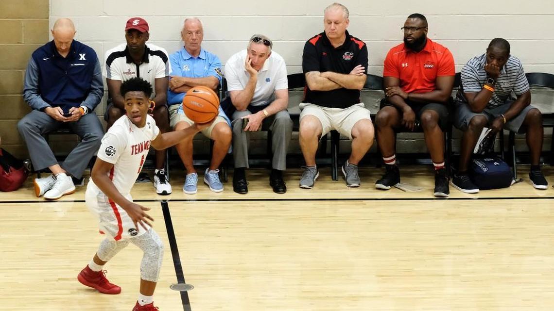 UNC coach Roy Williams and other basketball coaches watch a game during the opening night of the Nike Peach Jam at Riverview Park in North Augusta, S.C., on July 12, 2017. (AP Photo/Todd Bennett)