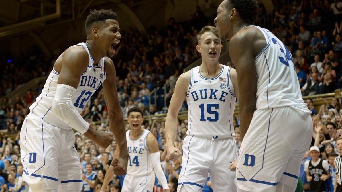 Freshmen players Javin DeLaurier (12), Jordan Goldwire (14), and Alex O’Connell (15) react after teammate Wendell Carter, Jr. (34) ends the half with a monster dunk. Duke played Northwest Missouri State in an exhibition game at Cameron Indoor Stadium in Durham, N.C. Friday, October 27, 2017.