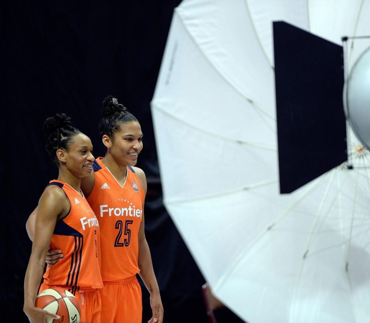 Connecticut Sun veterans Jasmine Thomas, left, and Alyssa Thomas pose for team photos in April.